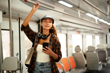 Young woman travelling by train. Beautiful girl typing a message while travel