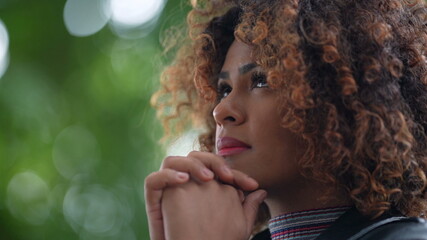 Brazilian woman looking up at sky with Hope and Faith