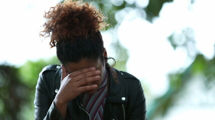 Brazilian woman feeling anxiety and stress. Person regret emotion