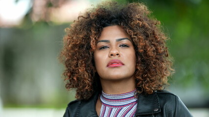 Brazilian black woman portrait close-up face looking at camera with curly hair