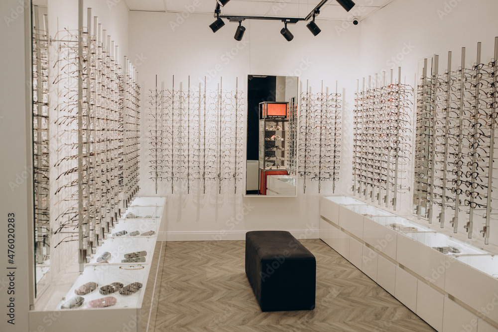 Wall mural optic shop with spectacles on shelves