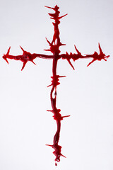 Fototapeta premium Barbwire crucifix made wit red paint resembling blood 
