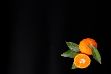 mandarins on black background , with a lot of copy space