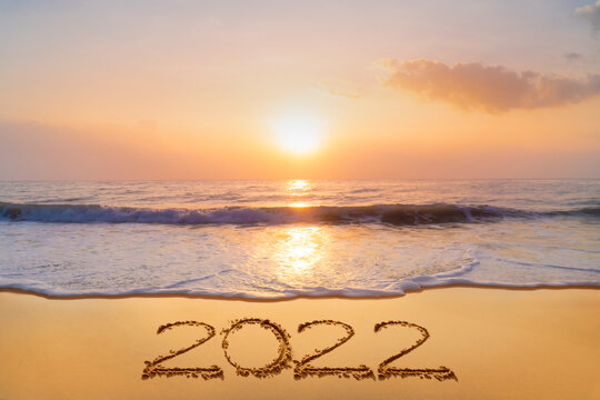 Celebrating the start of the new year 2022 With the handwriting on the beach in the morning.