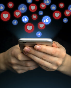 Social Media Concept. Hands Using Smartphone With Like Notification Icons. Social Networking, Black Background Photo