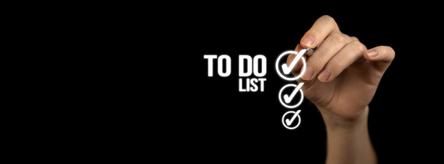 To do list with checklist boxes. Hand marking with pen on a black background, banner photo
