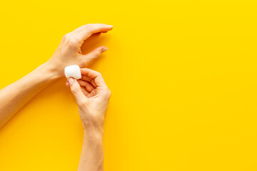 Cotton wool balls in female hands - clean and care for skin