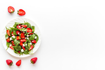 Vegetarian diet - green spinach salad with strawberry and goat cheese