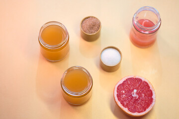 Cooking delicious gelatin dessert from fresh citrus fruit - orange jelly, brown sugar powder, gelatin and fresh grapefruit, top view