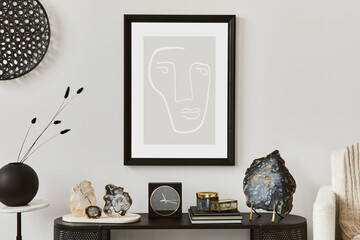 Creative composition of living room interior design with console, armchair, mock up poster frame, vase, gemstone and vintage personal accessories. Copy space. Template..