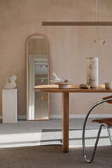 Elegant dining room interior composition with wooden dining table, armchair and design home decorations. Modern home staging. Rustic inspiration. Strucutre wall. Template. .