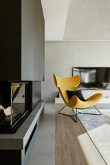 Stylish modern home interior of living room with design yellow armchair, chimney, concrete wall and personal accessories. Home decor. Template.