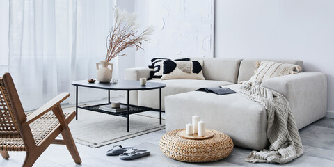 Domestic interior of living room with design modular sofa, black coffee table, lamp, decoration, art paintings, pouf, widnows and elegant personal accessories in modern home decor. Template.