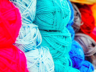 Skeins of woolen yarn of different colors. Full screen photo with center focus. Shop counter