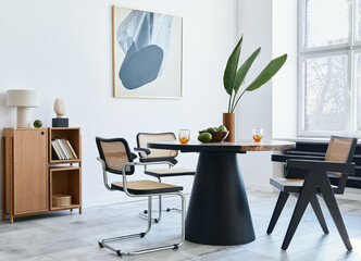 Stylish composition of dining room interior with design table, modern chairs, decoration, tropical...