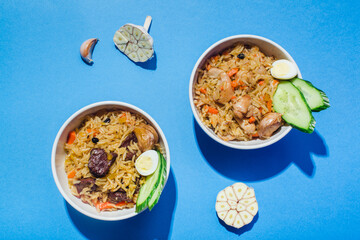 Traditional Uzbek oriental cuisine rice with meat plov on blue hair shadow modern style.