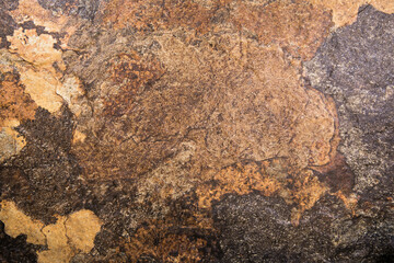 Top view of a brown stone texture splashed with gray and beige tones
