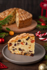 Traditional Christmas Dundee cake with dried fruits and almonds on a wooden board. Festive dessert. Rustic style, selective focus