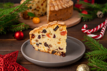 Traditional Christmas Dundee cake with dried fruits and almonds on a wooden board. Festive dessert. Rustic style, selective focus