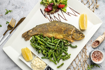 Grilled trout with parmesan, lemon and vegetables. Healthy fats, clean eating for weight loss