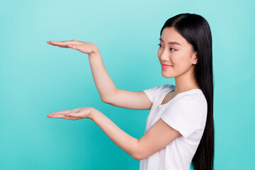 Profile side photo of young asian girl happy positive smile show hands size little isolated over...