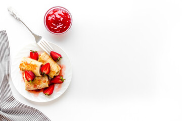 Hot french crepes with strawberry and berry sauce. Sweet dessert