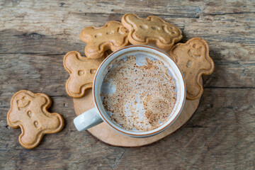 gingerbread cookies and coffee on wooden table for christmas
