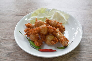 fried Thai northern east sausage stuffed rice and pork eat with fresh vegetable on plate