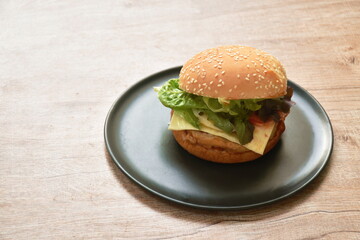 fried mashed chicken cheese hamburger and lettuce stuffed mayonnaise sauce with ketchup on plate