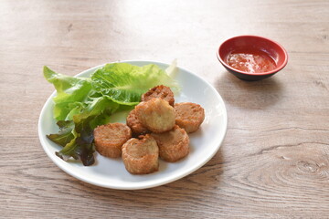 deep fried mashed crab meat and pork roll Chinese food on plate dipping sweet plum sauce