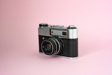 Purple instant camera on pink background