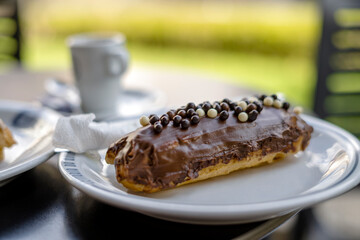 Tasty eclair pastry filled and covered  with chocolate