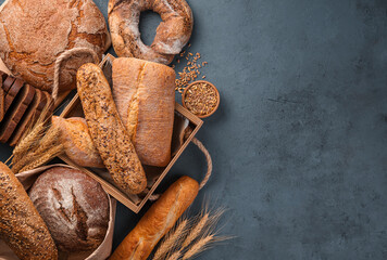 Wheat and rye whole grain bread on a graphite background.