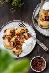 homemade dumplings with potatoes, fried bacon and onions