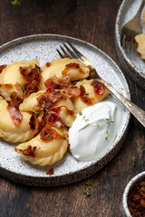 homemade dumplings with potatoes, fried bacon and onions