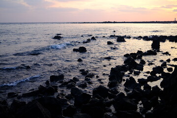 Fototapeta na wymiar Basalt rocks and beautiful sea wave in Jeju island, South Korea