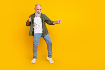 Full length body size photo of dancing elder man relaxing at party on holiday isolated bright yellow color background © deagreez
