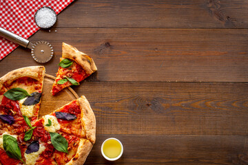 Pizza slices with tomatoes cheese and basil, top view
