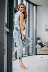 Young sexy woman st home in denim outfit
