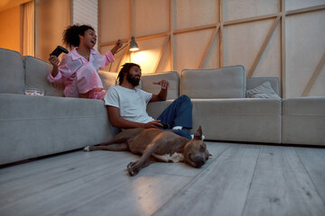 Girl celebrating victory over boy in video game