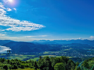 A view on the Lake Ossiach located in the heart of the Alps in Carinthia, Austria. The surface of the lake reflects golden sunbeams. The view is from a chapel on the hilltop of Oswaldiberg.