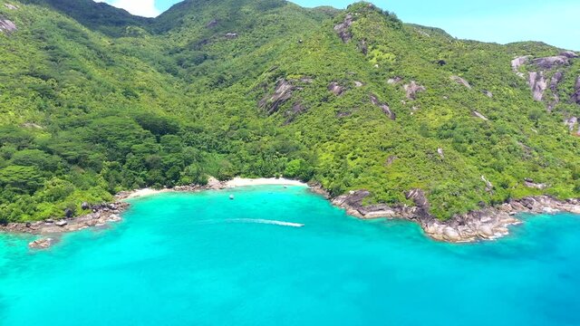 Drone clip at Anse Major beach on Mahe with turquoise blue water and palm trees in the Seychelles