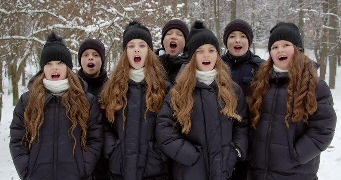 Many children open their mouths, sing a song of joy