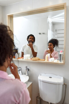 Young Black Couple Brushing Teeth At Morning