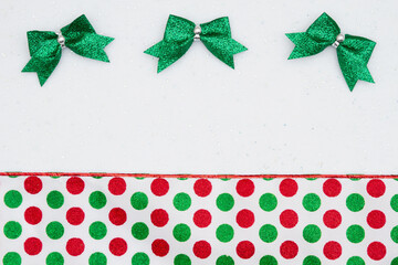 Christmas background with bows and red and green polka dots white sparkles felt
