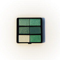 Mini palette of green eyeshadows. Isolated image on a white background. Nobody.