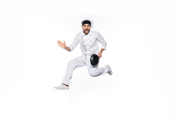 Fototapeta na wymiar amazed chef in hat and uniform jumping and holding frying pan isolated on white.