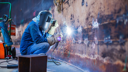 Welding male worker metal is part of machinery tank wall shell plate construction petroleum oil and...