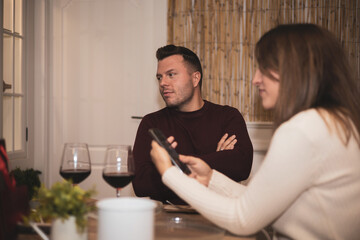 An adult man making an angry expression gesture on a bad date at the restaurant.Valentine's Day.