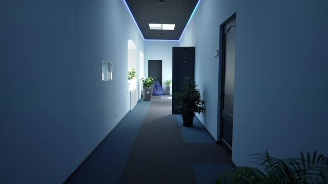 Live camera moves forward along empty business hall with no people on Covid-19 lockdown. Blue corporate premises with nobody on coronavirus quarantine. New normal